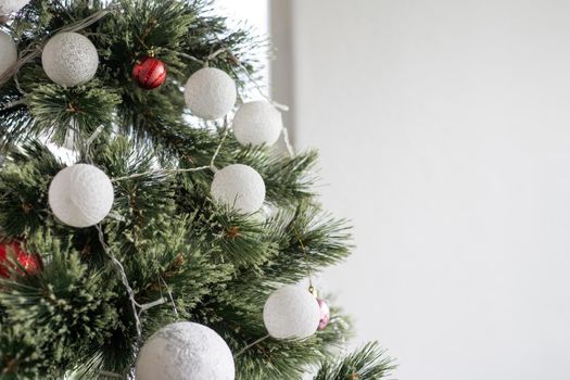 Christmas, New Year interior, decorated fir tree with garlands and balls.