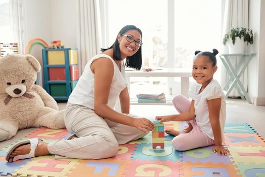 Mother, learning and child toy in home of knowledge development and education in a bedroom. Portrait of a happy family smile play a education game to build balance and children motor skills at home.