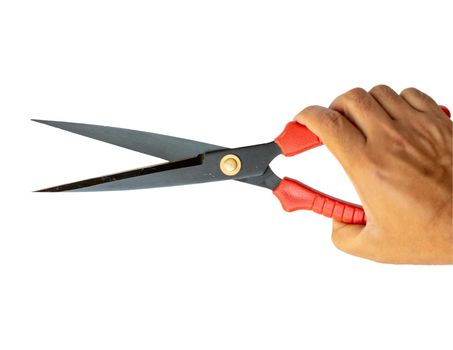 Red pruning shears holding in hand isolated on a white background