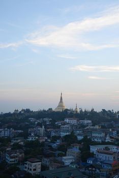 shwedagon pagoda surrounded by houses in yangon