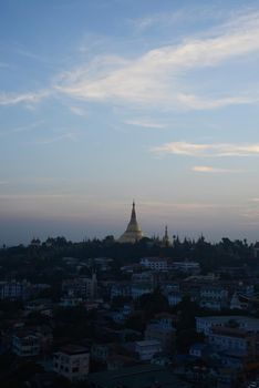 shwedagon pagoda surrounded by houses in yangon