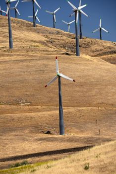 wind farm on a grass hill