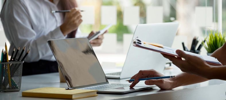 Close up business People Meeting to discuss and brainstorming the financial report paperwork in home office. Financial advisor teamwork and accounting concept