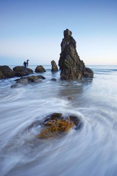 rock sea stack at a beach near malibu