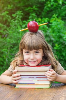 little girl student with a red apple. Selective focus. nature. nature.