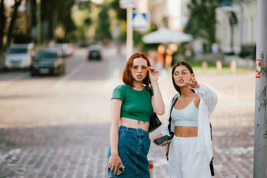 Two tourist friends consulting an online guide on a smart phone