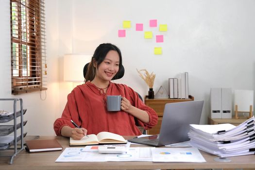 Asian business woman working in in coffee shop cafe with laptop paper work, Business woman concept..