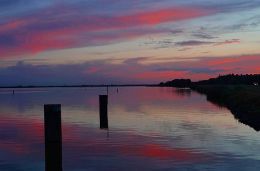 Dramatic sunset reflected in the water of the Veluwemeer, Netherlands