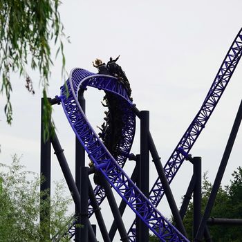 Loop in a rollercoaster. People having fun in an amusement park. Adrenaline boost