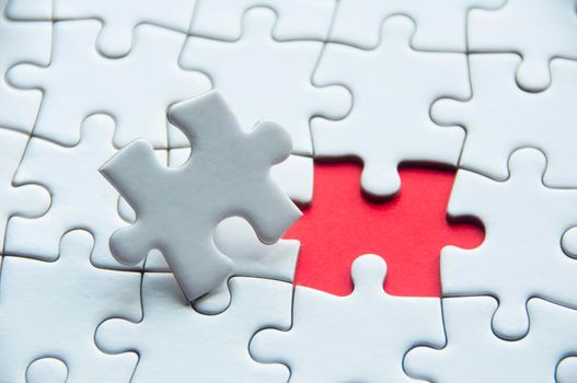 White jigsaw puzzle with customizable space for text or idea. Copy space
