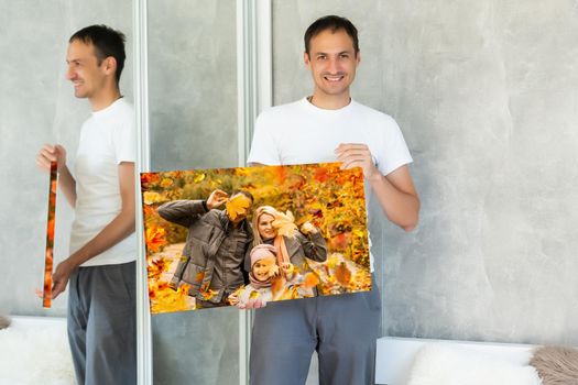 Canvas print with gallery wrap. man hangs autumn photography, photocanvas.