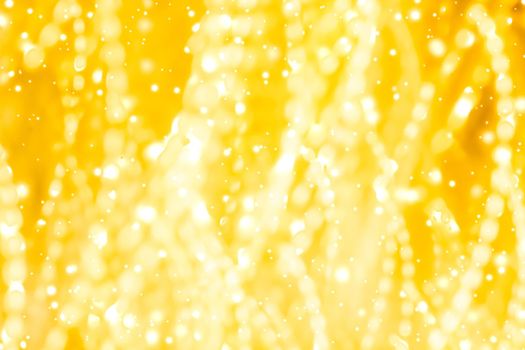 Golden Christmas lights, New Years Eve fireworks and abstract texture concept - Glamorous gold shiny glow and glitter, luxury holiday background