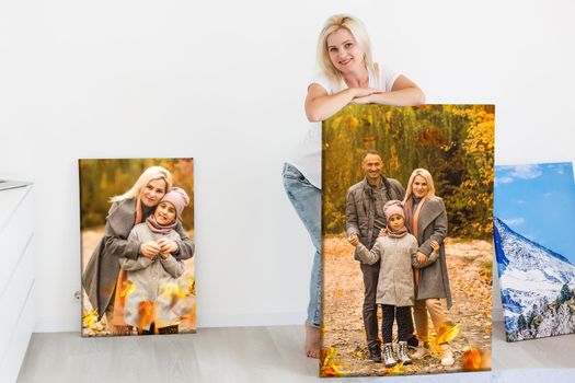 Canvas print with gallery wrap. woman hangs autumn photography, photocanvas.