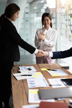 Business people shaking hands, finishing up meeting, business etiquette, congratulation, merger and acquisition concept.