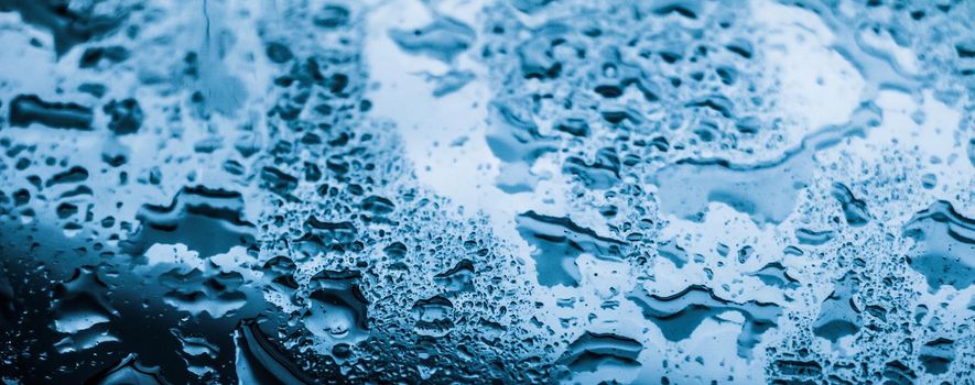 Liquid, wet and zen concept - Water texture abstract background, aqua drops on blue glass as science macro element, rainy weather and nature surface art backdrop for environmental brand design