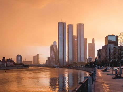 MOSCOW, RUSSIA - September 17, 2022. Gorgeous orange sunset of Capital Towers and Moscow City Business Center on Moscow-river embankment.