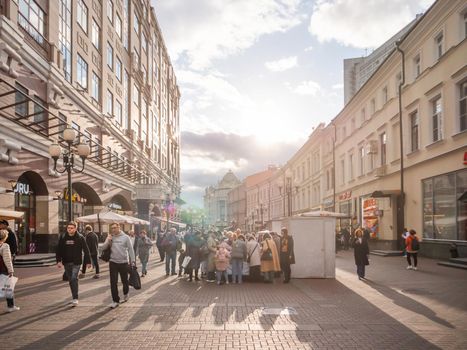 MOSCOW, RUSSIA - September 17, 2022. Local people and tourists walk on famous Arbat street. Autumn sunset over historical center of capital.