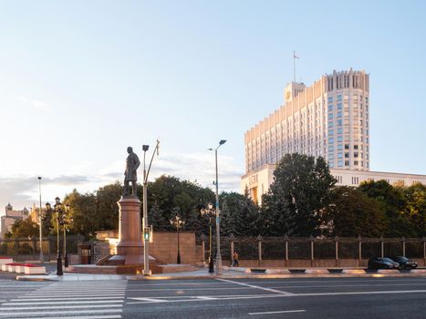 MOSCOW, RUSSIA - September 17, 2022. People go pass the White House, The House of the Government of the Russian Federation. Famous building at autumn sunset.