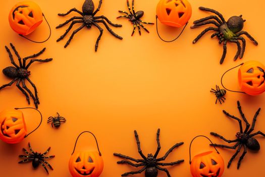 Halloween composition. Halloween decorations, pumpkins, spiders on orange background. Halloween concept. Flat lay, top view, copy space