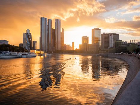 MOSCOW, RUSSIA - September 17, 2022. Gorgeous orange sunset of Capital Towers and Moscow City Business Center on Moscow-river embankment.