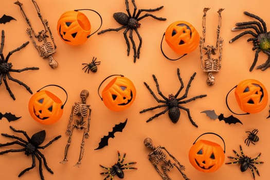 Halloween composition. Halloween decorations, pumpkins, bats, spiders on orange background. Halloween concept. Flat lay, top view