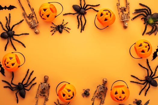 Halloween composition. Halloween decorations, pumpkins, bats, spiders on orange background. Halloween concept. Flat lay, top view, copy space