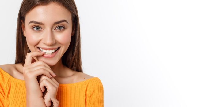 Close-up portrait of yong woman casual portrait in positive view, big smile, beautiful model posing in studio over white background