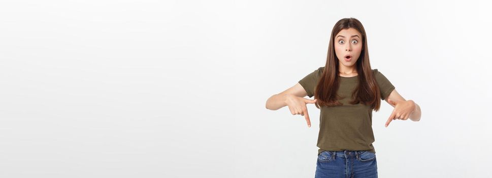 amazement - woman excited looking to the side. Surprised happy young woman looking sideways in excitement. Mixed race Asian and white Caucasian female model on grey background