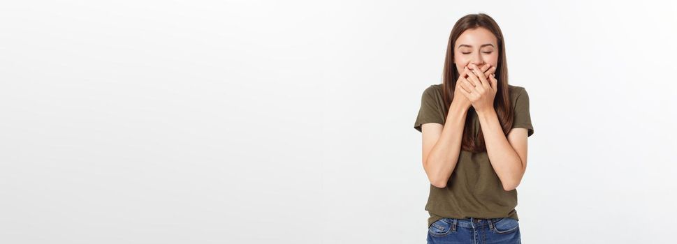 Happy woman laughing covering her mouth with a hands isolate over grey background