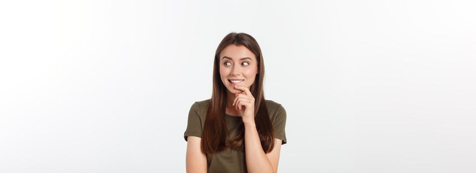 amazement - woman excited looking to the side. Surprised happy young woman looking sideways in excitement. Mixed race Asian and white Caucasian female model on grey background