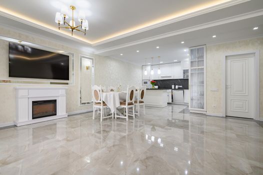 Luxurious white large home kitchen with dining table and marble floor, lots of copyspace