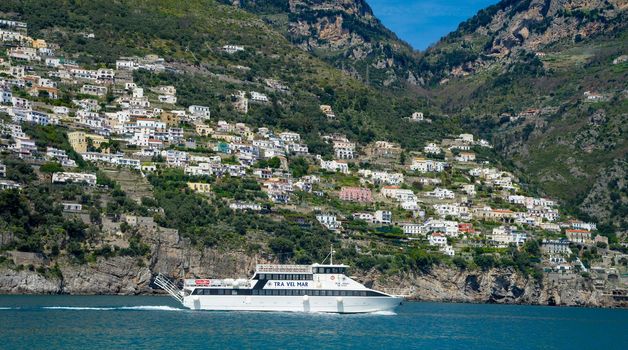 Amalfi Coast Italy photographed from the ferryboat on a sunny day with colourful houses visible on the coast 2022 april 15