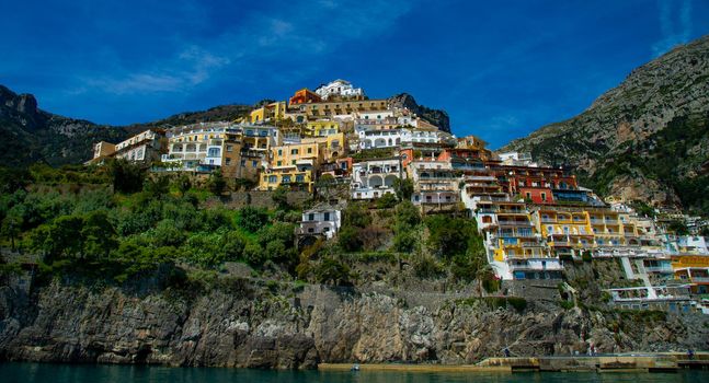 Amalfi Coast Italy photographed from the ferryboat on a sunny day with colourful houses visible on the coast 2022 april 15