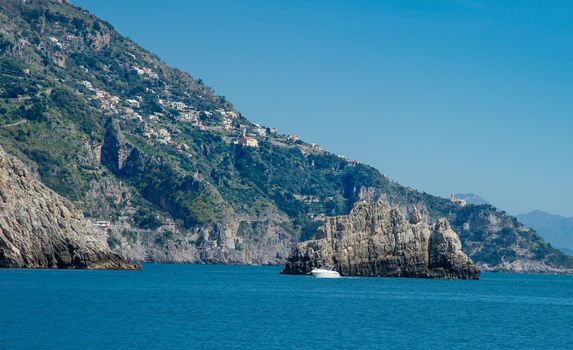 Amalfi Coast Italy photographed from the ferryboat on a sunny day with colourful houses visible on the coast 2022 april 15