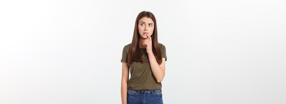 Portrait happy and surprised young lady standing isolated over grey background. Looking camera pointing