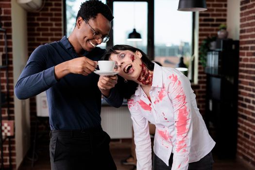 Evil cruel zombie chatting with man in office, brain eating monster with bloody scars and ugly wounds being in startup business workplace. Woman evil corpse talking to businessman.