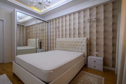 Cozy and well designed luxury master bedroom in beige tones with elegant and modern details
