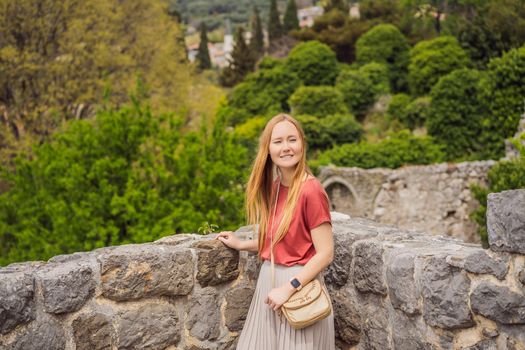 Woman tourist walks through the old town of Bar in Montenegro. Happy tourist walks in the mountains. Suburbs of the city of Bar, Montenegro, Balkans. Beautiful nature and landscape.