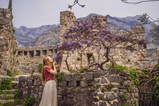 Woman tourist walks through the old town of Bar in Montenegro. Happy tourist walks in the mountains. Suburbs of the city of Bar, Montenegro, Balkans. Beautiful nature and landscape.