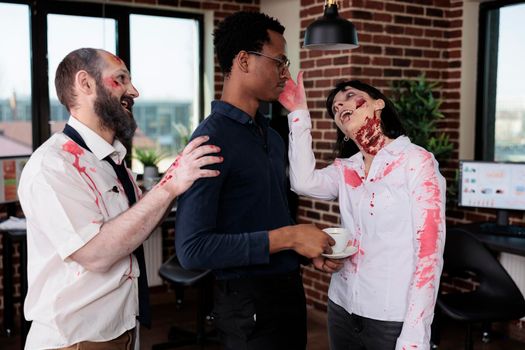 Creepy evil monsters attacking scared man in business office, aggressive dangerous zombies corpses chasing person being frightened. Brain eating devil group acting cruel and bloodthirsty.