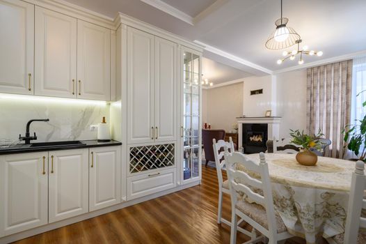 Modern classic large white colored luxurious kitchen and dining room in studio apartment interior