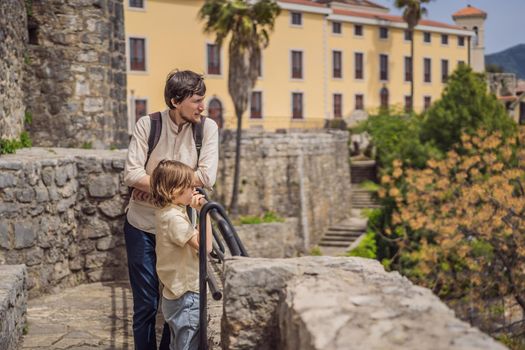 Father and son tourists in Herceg Novi old town. Historical and touristic center of Herceg Novi. Montenegro.