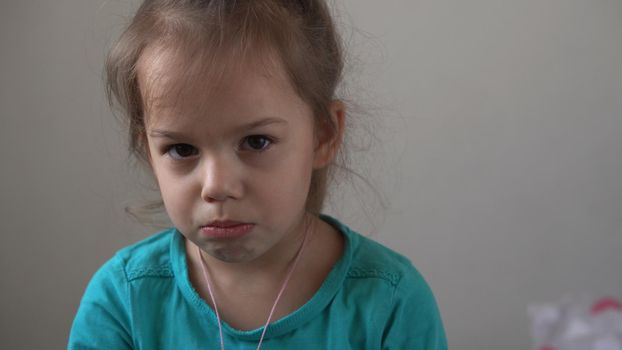 Portrait little girl sad upset child burst into tears cries sob looking at camera indoors. sincere children emotions feelings at home crying kid with pretty face. Concept childhood insult offend grief.