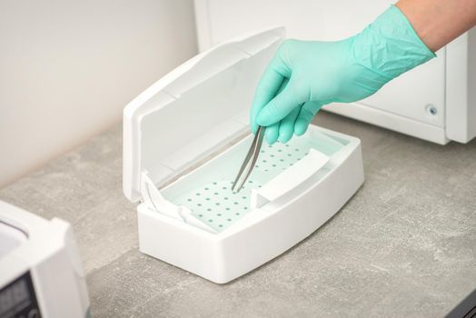 Hand disinfects tweezers with cleaning systems for medical instruments. Ultrasonic cleaner