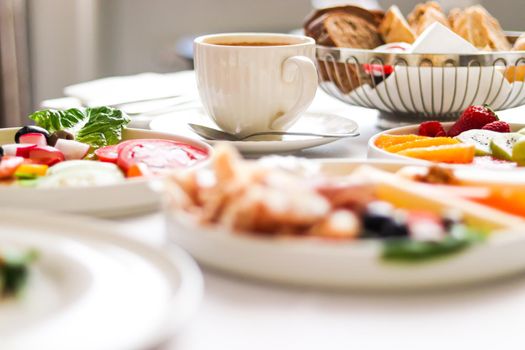 Luxury hotel and five star room service, various food platters, bread and coffee as in-room breakfast for travel and hospitality brand