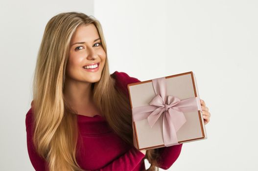 Holiday present for birthday, baby shower, wedding or luxury beauty box subscription delivery, happy woman holding a wrapped pink gift on white background