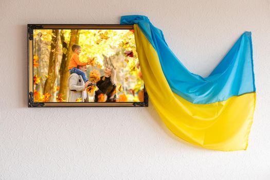 photo canvas with a family in autumn, the flag of Ukraine.