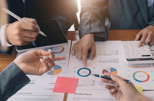 Teamwork with business people analysis cost graph on desk at meeting room..