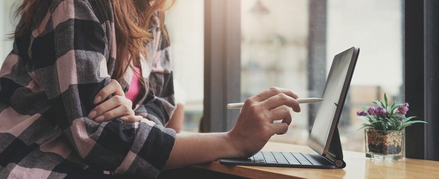 Close up of woman working By typing on the laptop keyboard at the office.