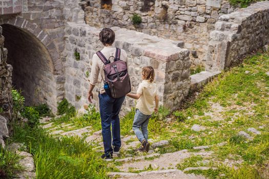 Dad and son tourists walks through the old town of Bar in Montenegro. Happy tourist walks in the mountains. Suburbs of the city of Bar, Montenegro, Balkans. Beautiful nature and landscape.